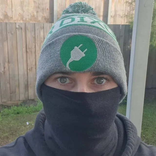 Candid JR Dixon Electrical team photo wearing a knitted beanie and face covering