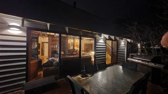 Wall lights installed by JR Dixon Electrical along an outdoor entertaining deck