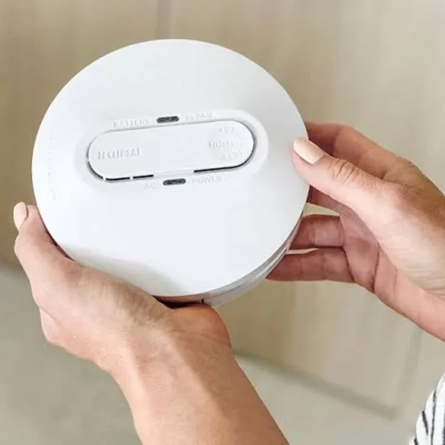 JR Dixon Electrical smoke alarm reminder showing a smoke alarm being checked